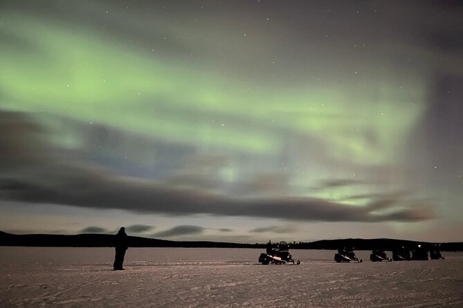 Northern Light snowmobile tour in Kiruna 7:30 pm - Passing the Icehotel on the Torne River